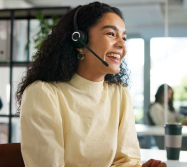 Smiling agent wearing a headset in an office, illustrating friendly service in call centers-1