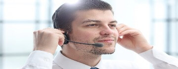 Customer service agent adjusts his headset and microphone during a shift where call centers are one of the most structured career environments for young professionals.