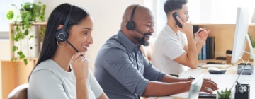 Multicutural call center, customer service or support with consultant people at work in an office for assistance. Contact us, crm or consulting with a group of employees using headset technology for telemarketing.