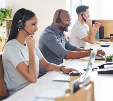 Multicutural call center, customer service or support with consultant people at work in an office for assistance. Contact us, crm or consulting with a group of employees using headset technology for telemarketing.