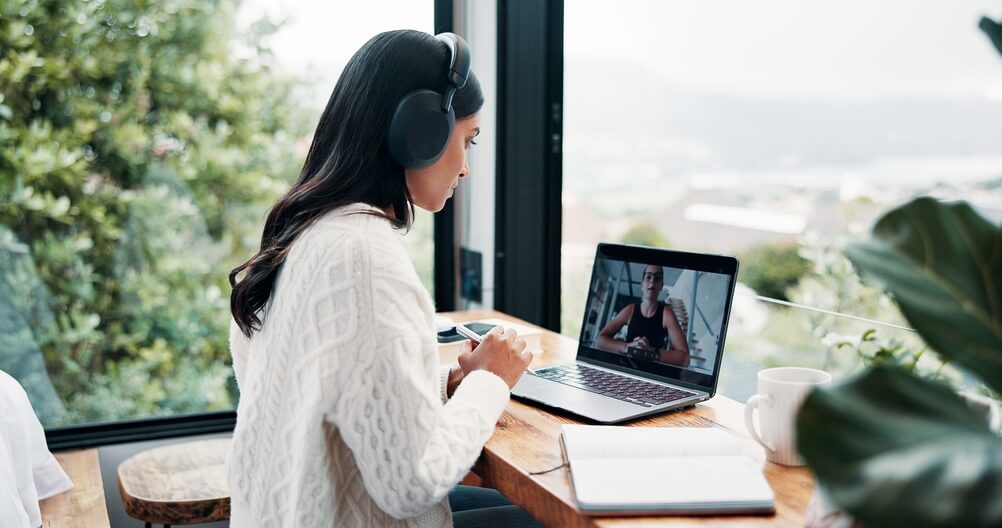 Job candidate attending a virtual interview from home, illustrating the appropriate dress code for a call center interview in an online setting.