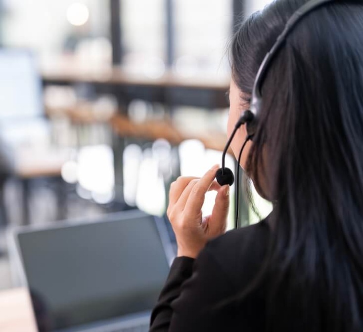 Call center agent wearing a headset while supporting the customer journey.