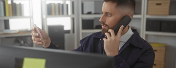 Call center agent applying a detective mindset while examining clues and speaking on the phone to solve customer problems-1