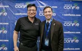 Confie's CEO posing with a Guest in front of a Confie backdrop