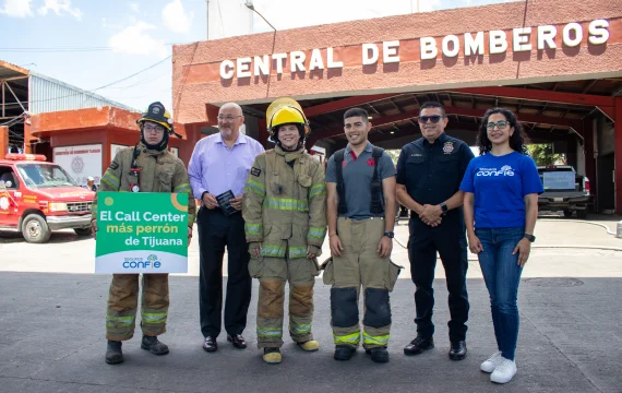 Confie members alongside firefighters in front of Tijuana's Fire Department