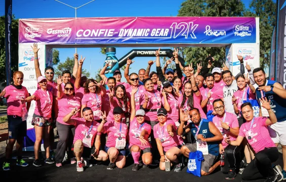 Happy runners after a race against breast cancer