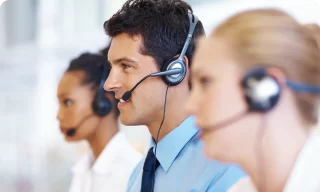 busy male support service operator talking to customer sitting at desk young professional business