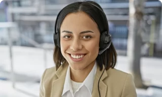 Smiling businesswoman with long hair in beige blazer outdoors