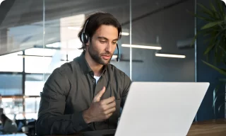 busy male support service operator talking to customer sitting at desk young professional business