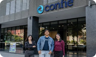 Three employees stand in front of a Confie office building entrance.