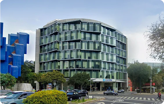 A modern office building with a Confie sign at street level, labeled CDMX office.